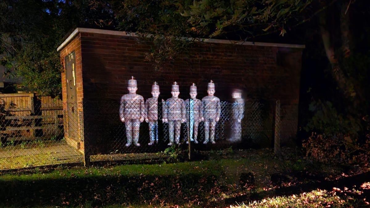 Soldiers projected onto the wall of a former service station along the ghost walk route